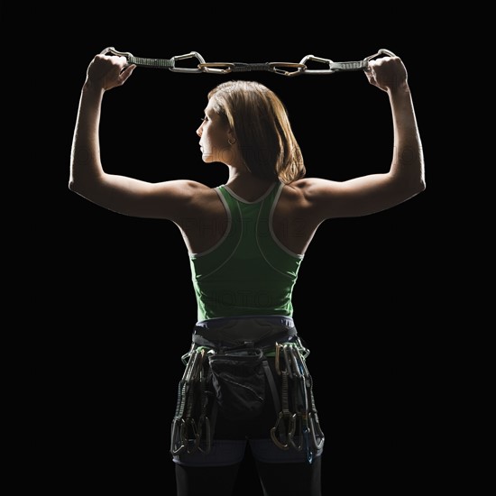 Female climber holding gear