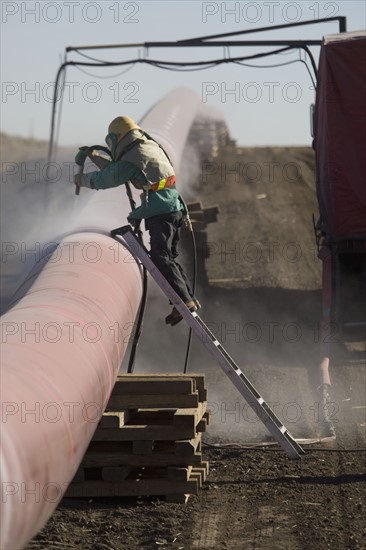 Construction worker cleaning pipleline