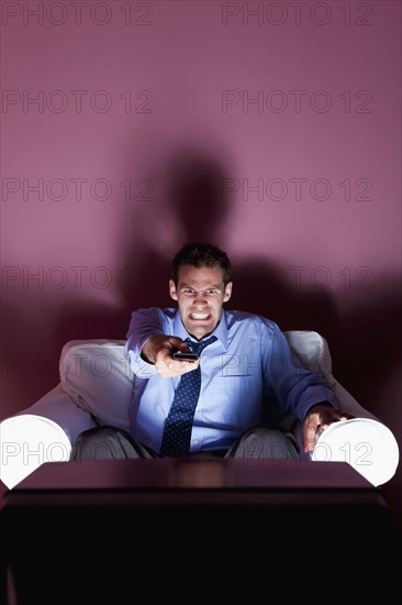 Angry man using remote control