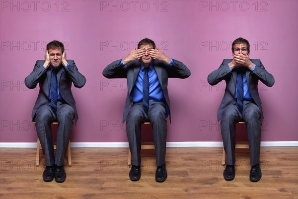 Three businessmen sitting in chairs