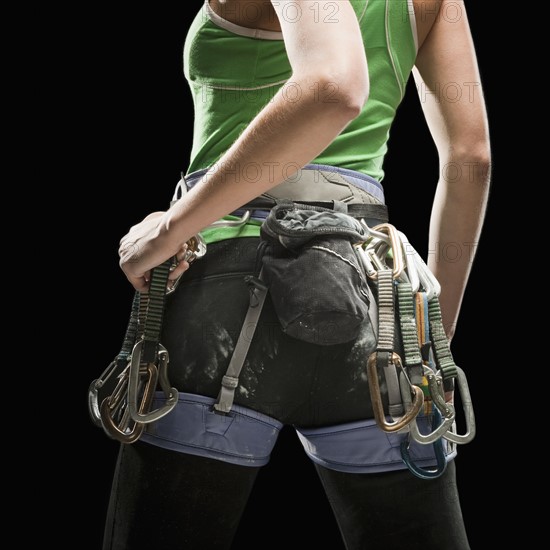 Studio shot of female climber wearing harness