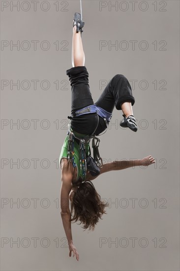 Female Climber hanging upside down