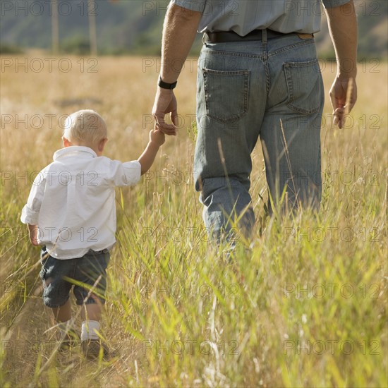 Child holding father's hand