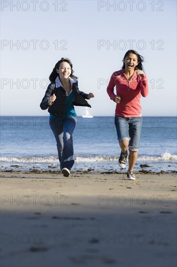 Girls running on beach