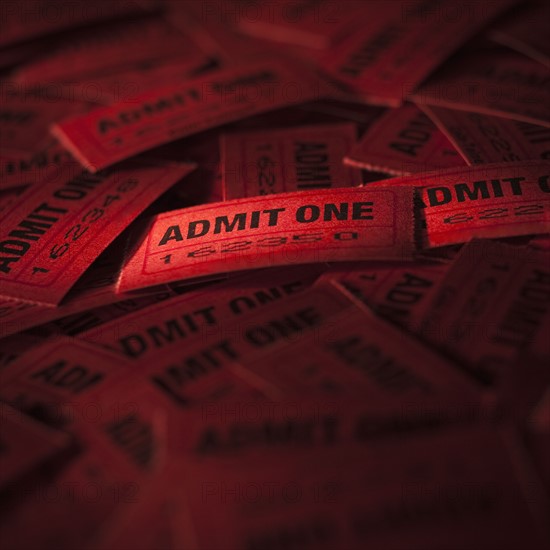 Pile of red admit one tickets