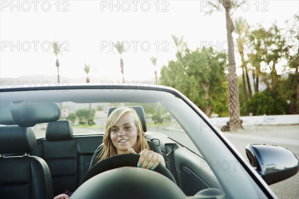 Woman driving convertible