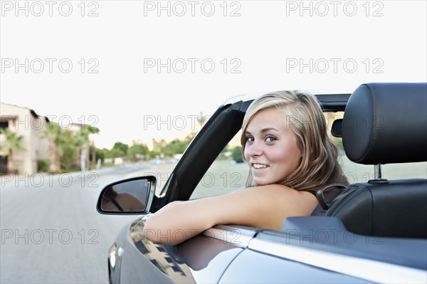 Woman driving convertible