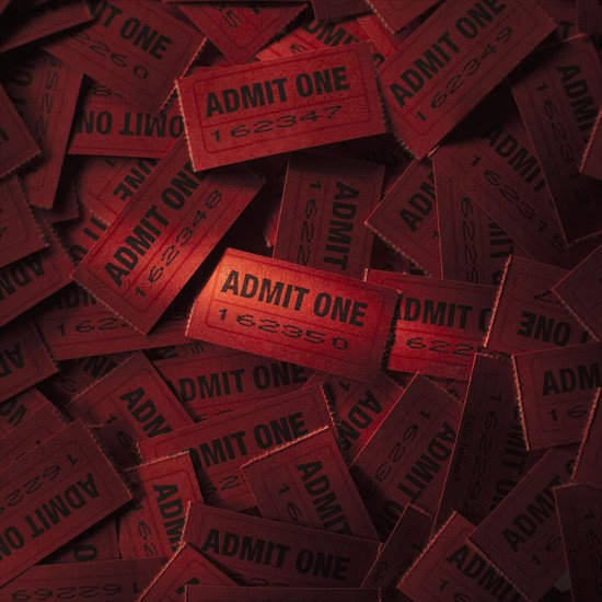 Pile of red admit one tickets