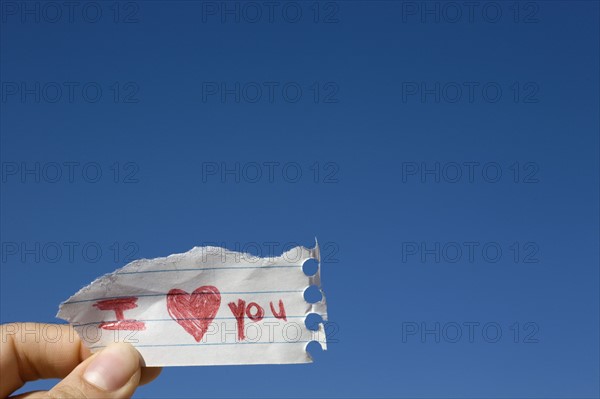 Hand holding note