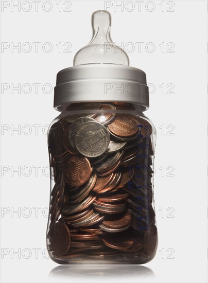 Baby bottle full of coins