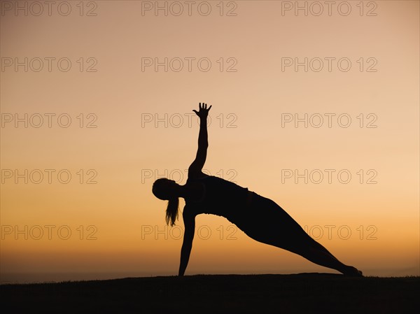 Silhouette of woman doing yoga