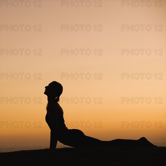 Silhouette of woman doing yoga