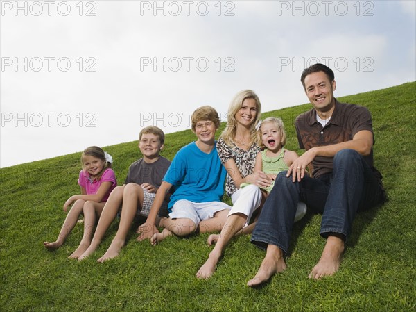 Family sitting on grass