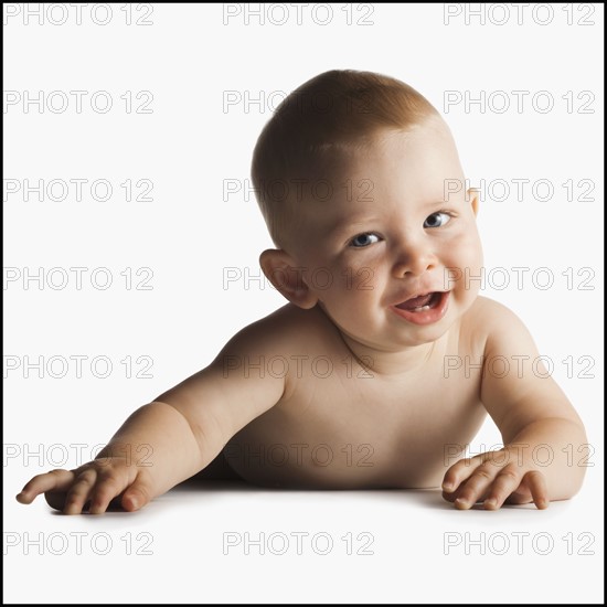 Smiling naked baby lying on tummy