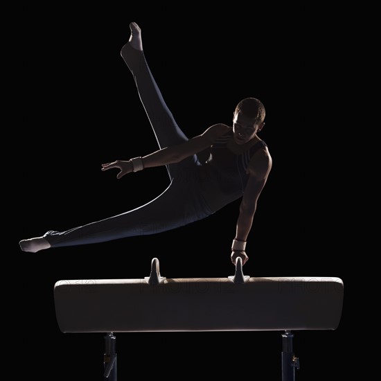 Male gymnast on pommel horse