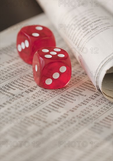 Two dice on newspaper