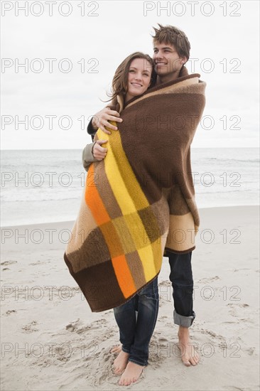 Couple wrapped in blanket