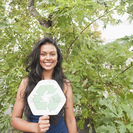Woman holding recycle sign