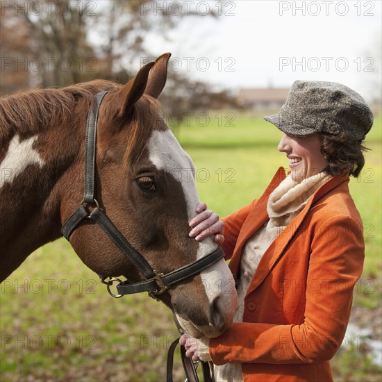 Woman petting horse.