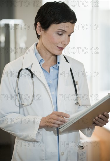 Doctor looking at chart.