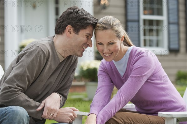 Couple in front of house.