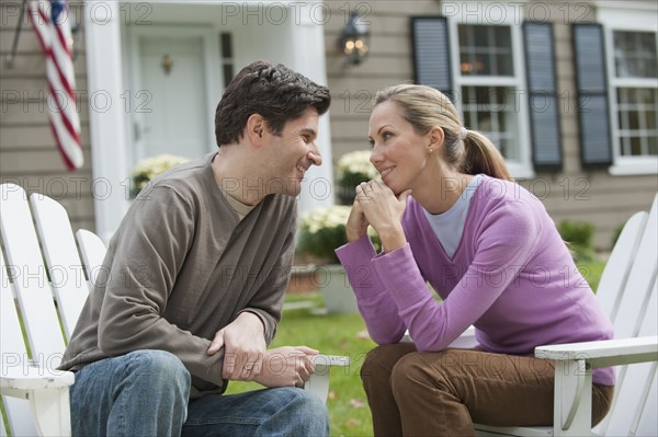 Couple in front of house.