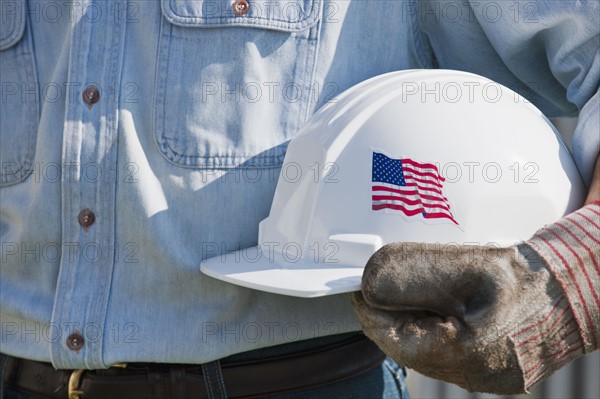 Man holding hardhat.