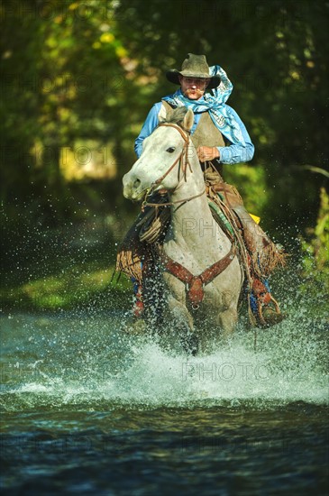 Riding horse through water.