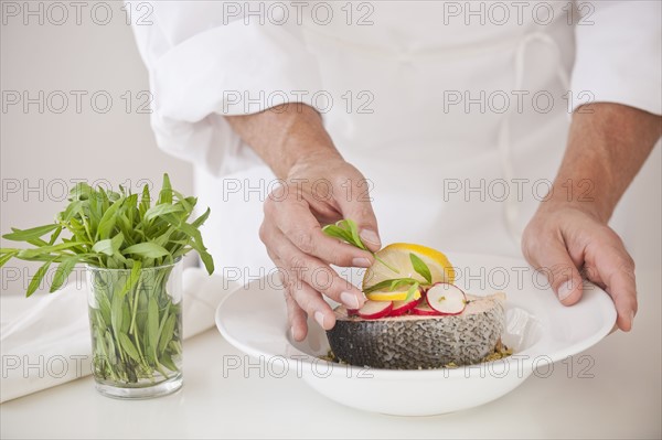 Chef preparing fish.