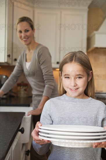 Girl holding plates.