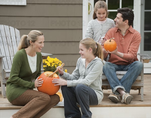 Family sitting on deck.