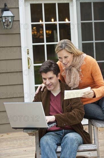 Couple looking at laptop.