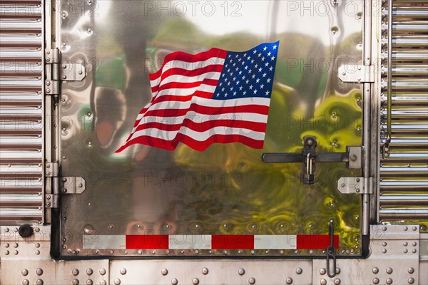 Side of truck with American flag.