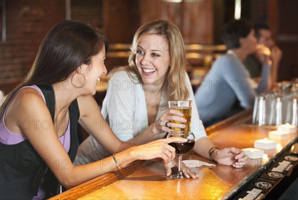 Friends drinking at bar.