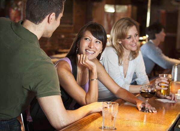 Friends drinking at bar.