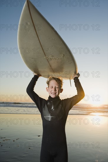 Child holding surfboard