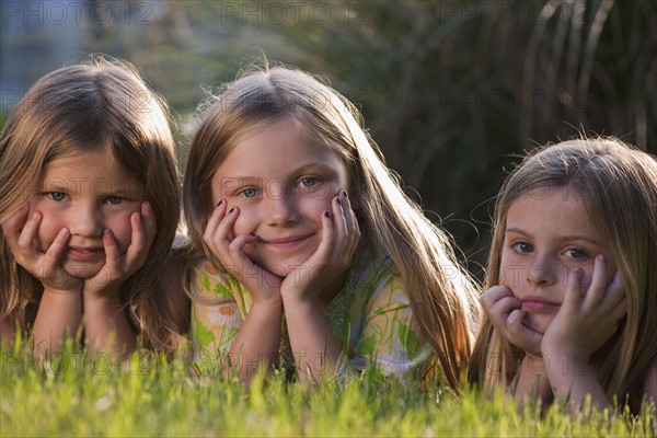 Young girls lying on grass