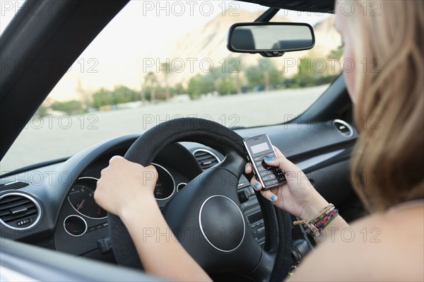 Woman driving convertible