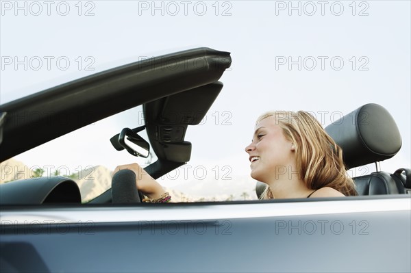 Woman driving convertible