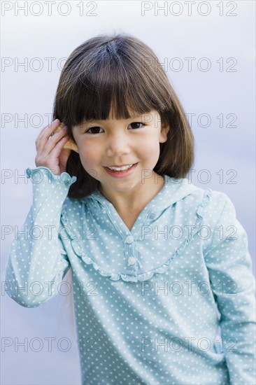 Young girl holding seashell