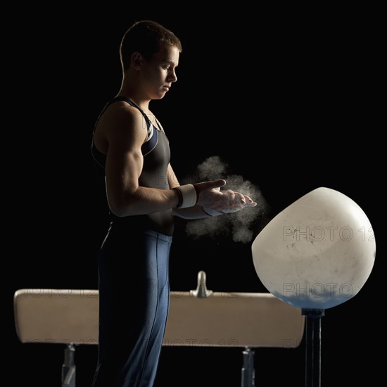 Gymnast beside pommel horse