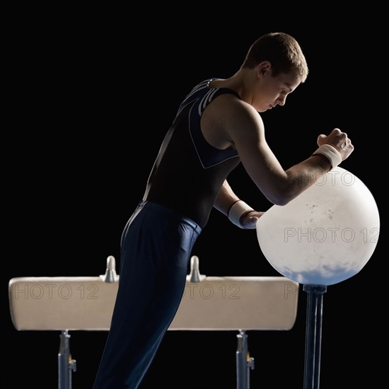 Male gymnast on pommel horse