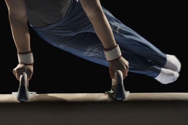 Gymnast swinging on pommel horse