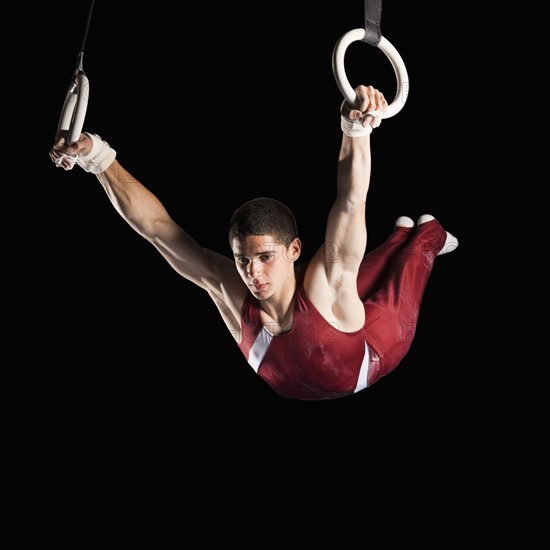 Gymnast swinging from rings