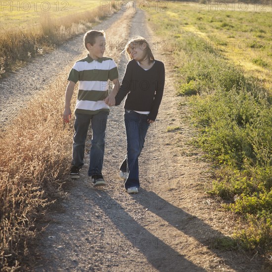 Young children walking and holding hands