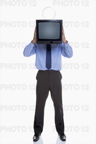 Man holding television in front of face