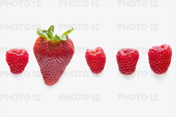 Four raspberries and one strawberry