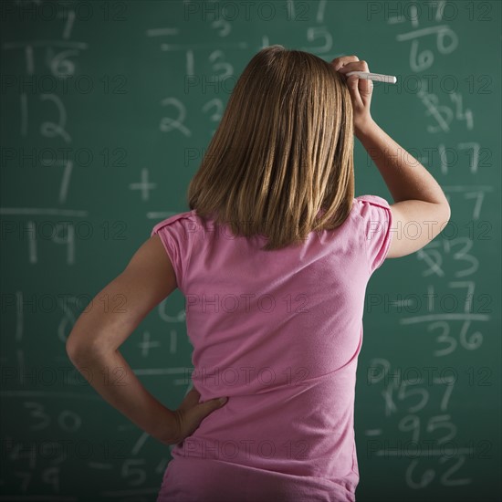 Student in front of chalkboard