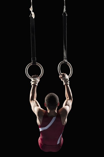 Gymnast swinging from rings