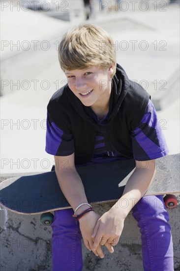 Boy holding skateboard